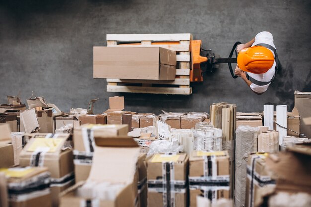 Young man working at a warehouse with boxes