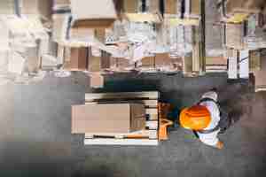 Free photo young man working at a warehouse with boxes