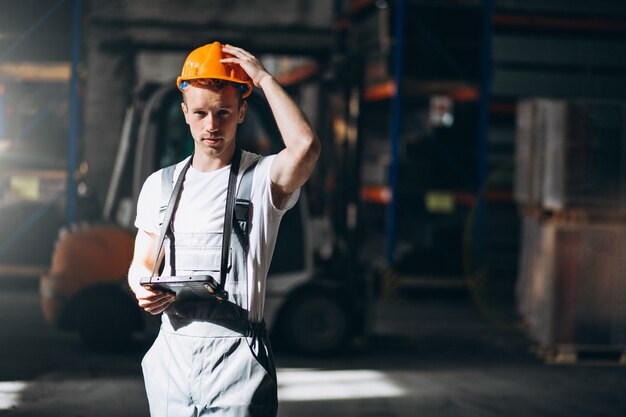 Young man working at a warehouse with boxes