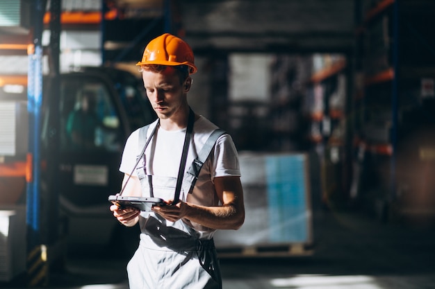 Young man working at a warehouse with boxes