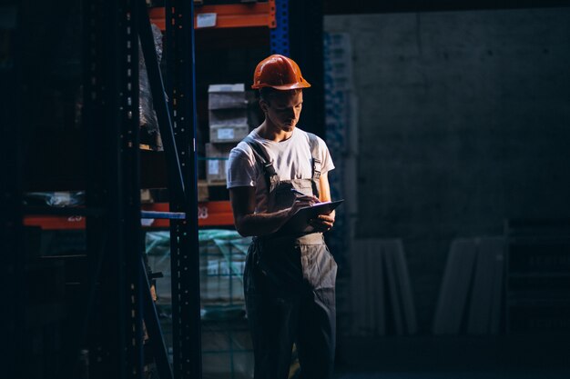 Young man working at a warehouse with boxes