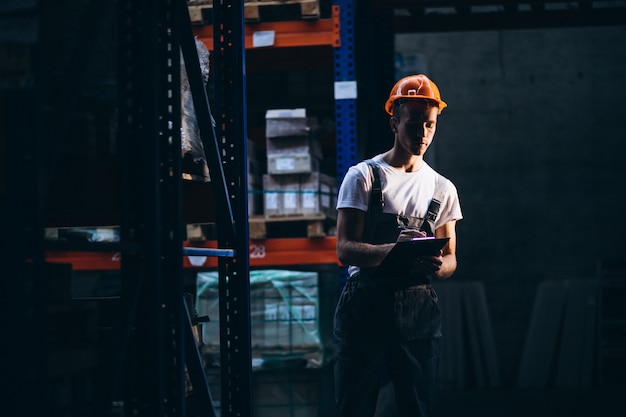 Young man working at a warehouse with boxes