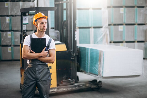 Young man working at a warehouse with boxes