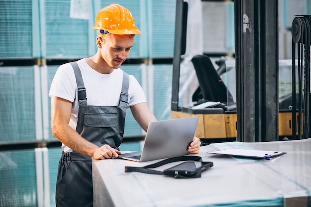 Free photo young man working at a warehouse with boxes