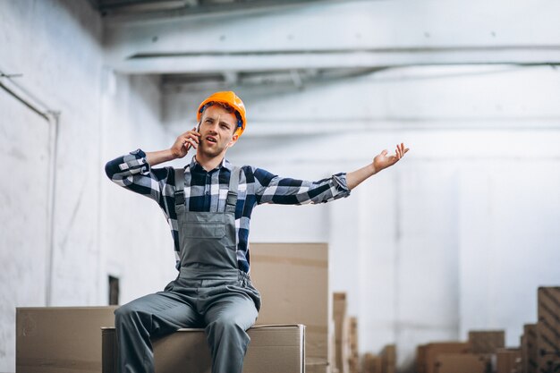 Young man working at a warehouse with boxes