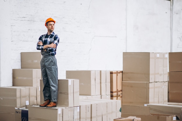 Young man working at a warehouse with boxes