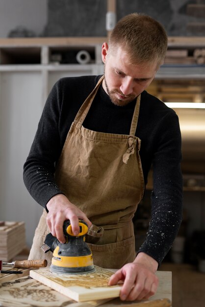 Young man working in a wood engraving workshop