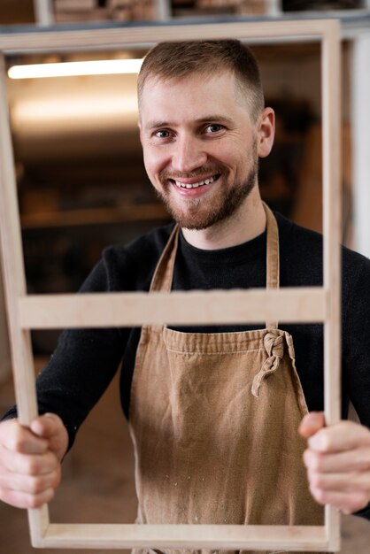 Young man working in a wood engraving workshop