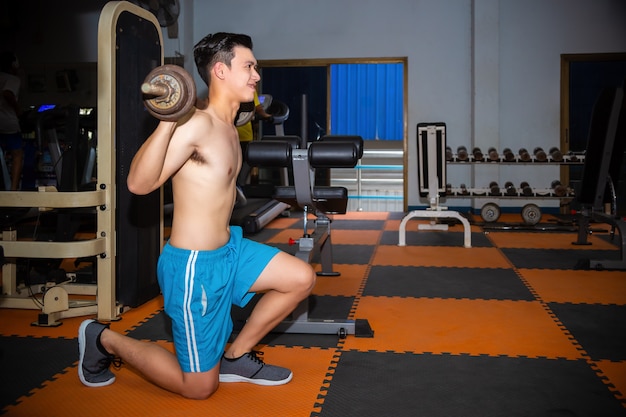 Free photo young man workouts at fitness gym