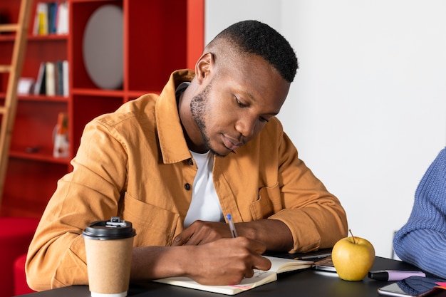 Free photo young man writing during study session