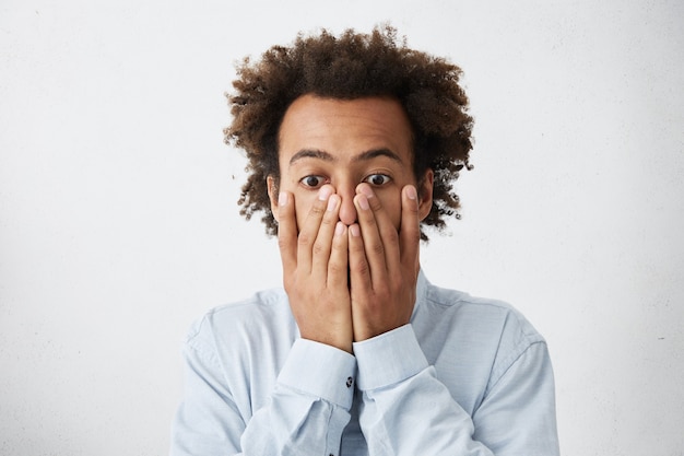 young manager covering face with both hands