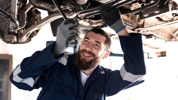 Young mechanic working at his workshop