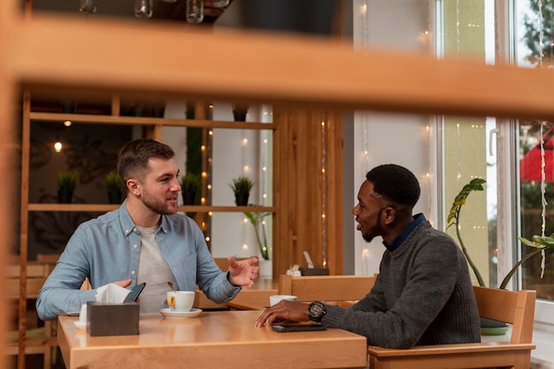 Young men having coffee together