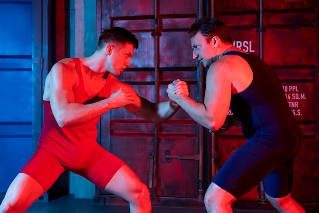 Young men in sportswear wrestling each other