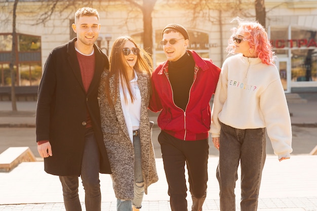 Young men and women walking in city