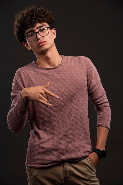Young model in casual fall winter outfits and eyeglasses. 