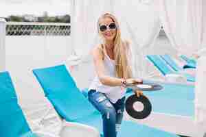 Free photo young model playing with vinyl records