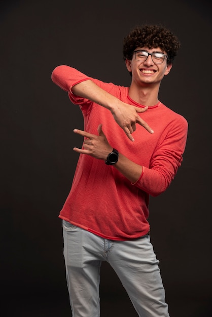 Young model in red shirt posing positive. 