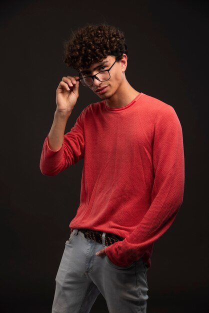 Young model in red shirt wearing eyeglasses. 