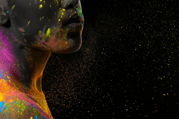 Young model with colorful powder close up