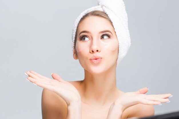 Young model with towel on head with cosmetics treatments