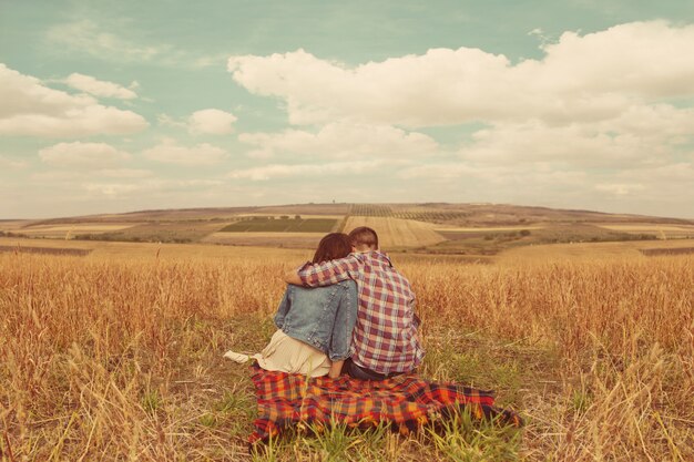 Young modern stylish couple outdoors. Romantic young couple in love outdoors in the countryside