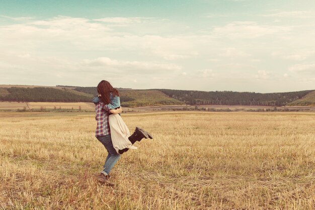 Young modern stylish couple outdoors. Romantic young couple in love outdoors in the countryside