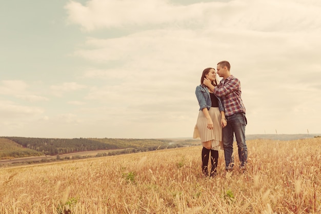 Young modern stylish couple outdoors. Romantic young couple in love outdoors in the countryside