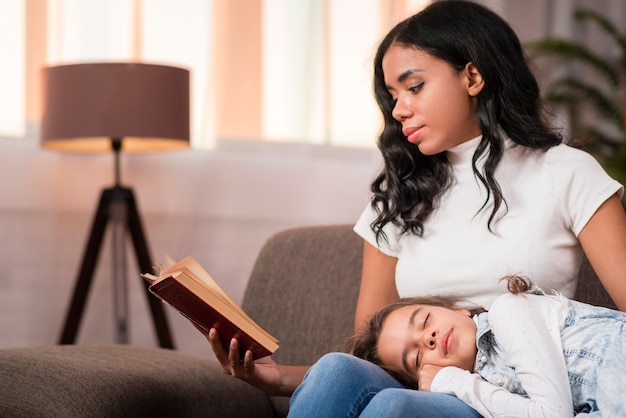 Young mom reading stories for daughter