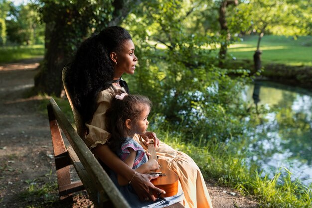 Young mom with her daughter spending time in nature