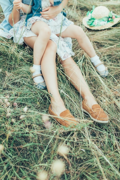 Free photo the young mother and daughter on green grass