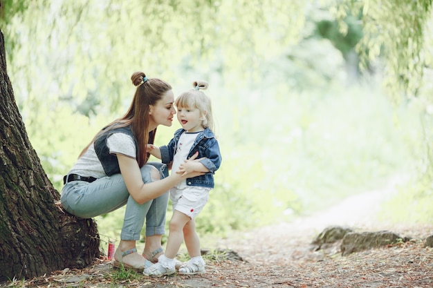 Young mother having fun with her daughter outdoors