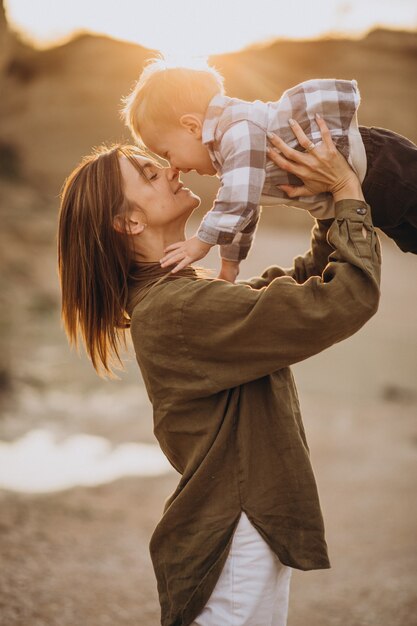 Young mother having fun with her little son