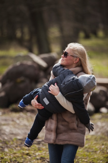 Free photo young mother holding her son