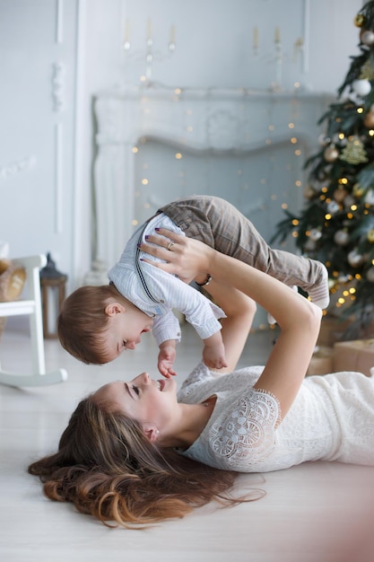 young mother playing with cute baby