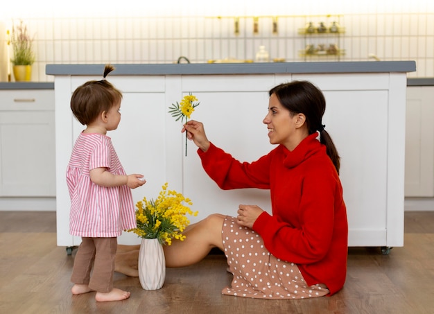 Free photo young mother spending time with her daughter