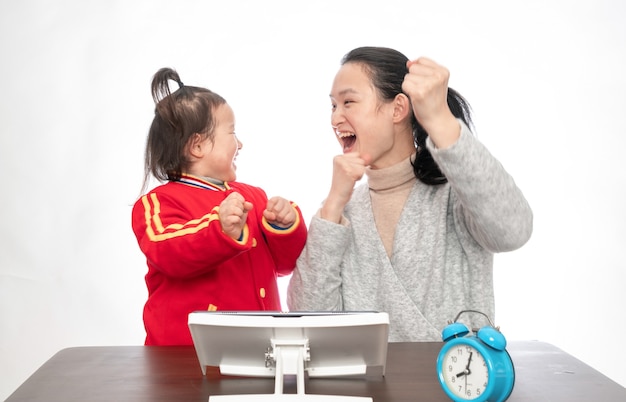 Young mother teaches daughter to paint