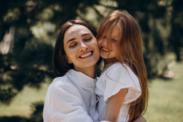 Young mother with daughter having picnic in the backyard