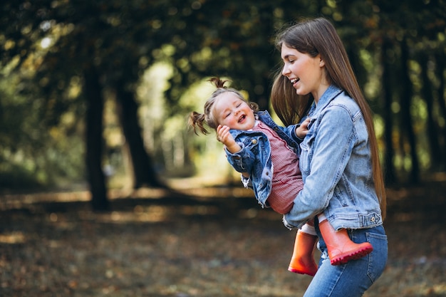 Бесплатное фото Молодая мать с маленькой дочерью в осеннем парке