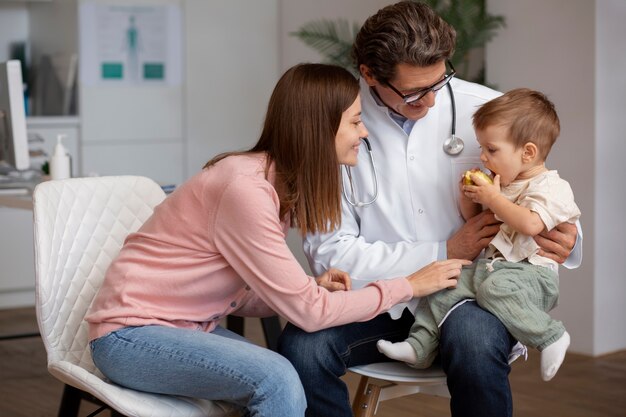 Young mother with her toddler at the pediatrician for a physical examination