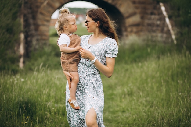 Young mother with little daughter in park