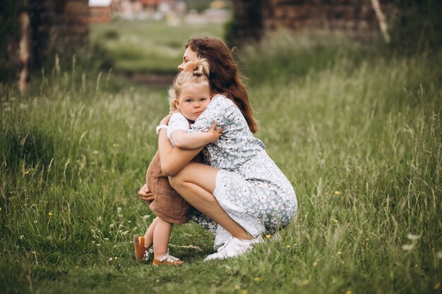 Young mother with little daughter in park