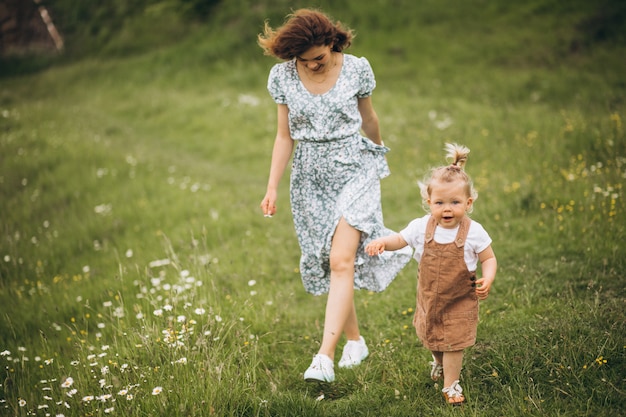 Young mother with little daughter in park