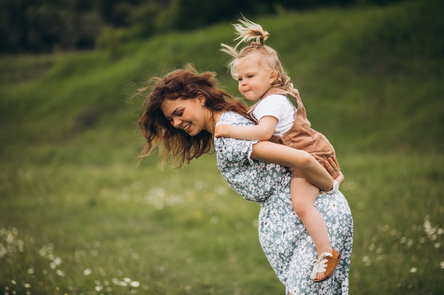 Young mother with little daughter in park