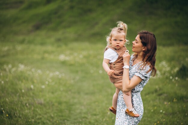 Young mother with little daughter in park