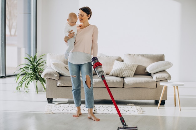 Young mother with toddler son cleaning up at home