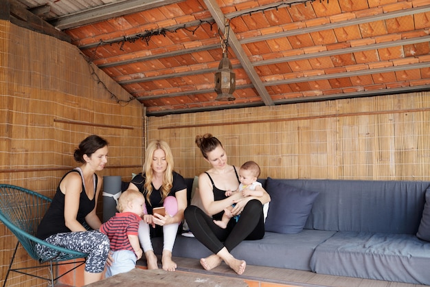 Free photo young mothers in yoga studio