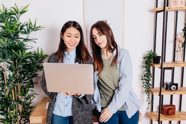 Young multiracial women with laptop