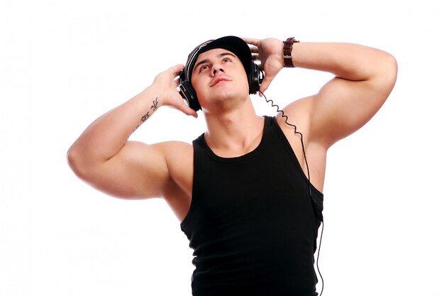 Young muscular man listen music