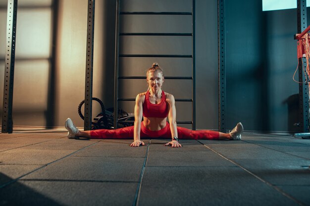 Young muscular woman practicing in gym